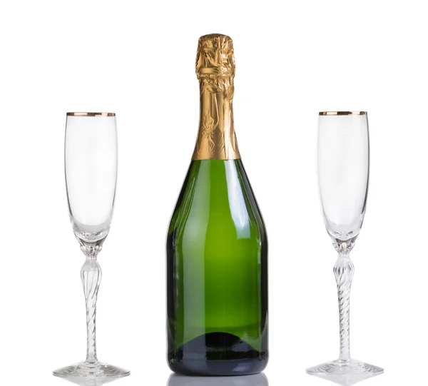 Unopened bottle of champagne and drinking glasses isolated on wh — Stock Photo, Image
