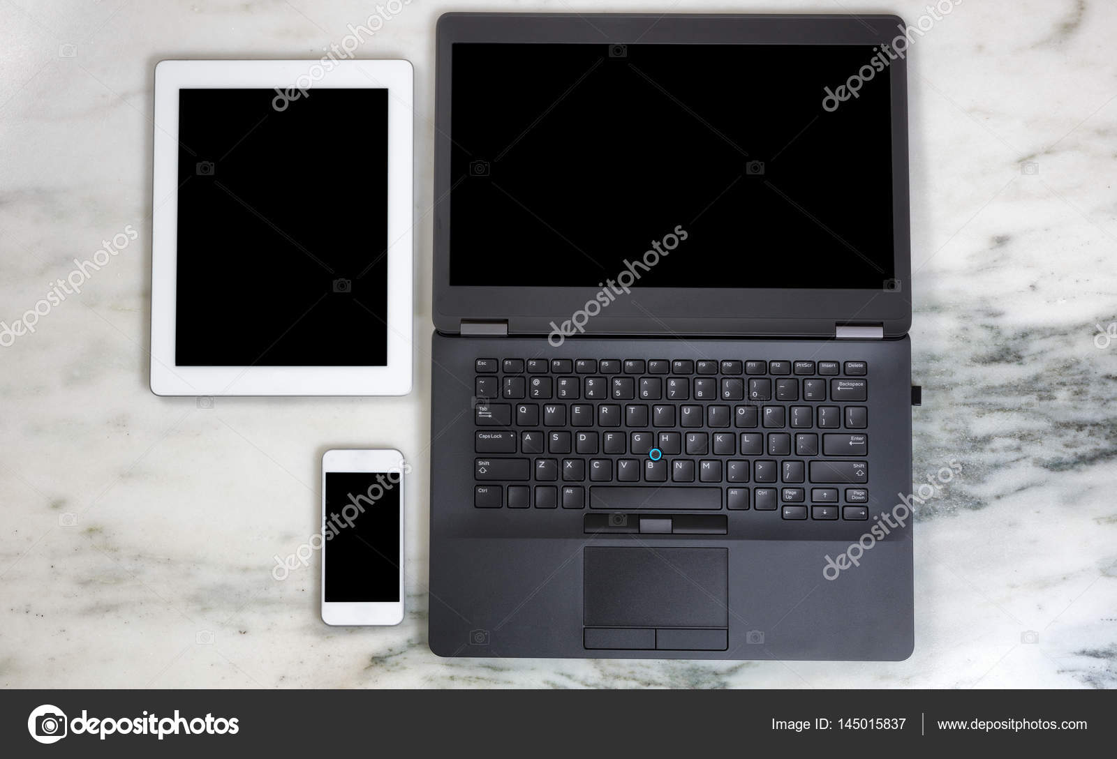 Modern mobile communication devices and computer on marble deskt Stock Photo by ©tab62 145015837