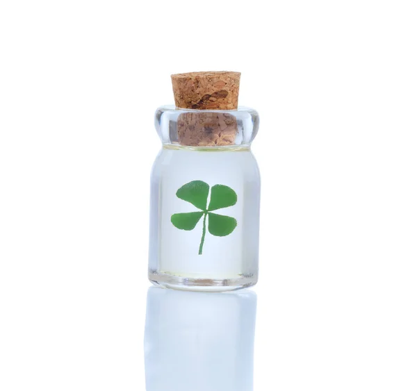 Four leaf clover in bottle for St. Patrick day symbol isolated o — Stock Photo, Image