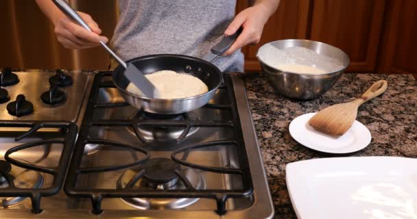 Переворачиваю блины на сковородке. — стоковое видео