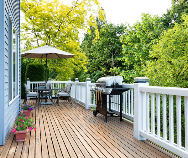 Home deck and patio with outdoor furniture and BBQ cooker with b