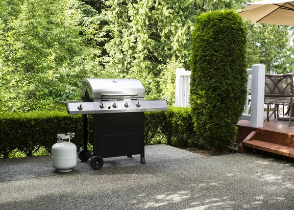 Outdoor cooker on House concrete patio with home deck on side — Stock Photo, Image