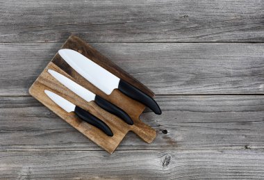 Ceramic knife set on rustic server board 