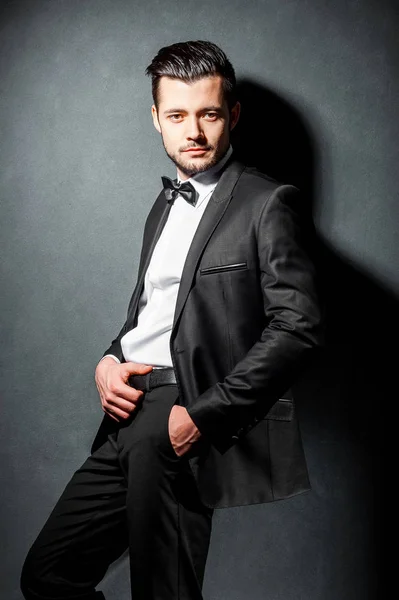 Portrait of confident handsome man in black suit with bowtie — Stock Photo, Image