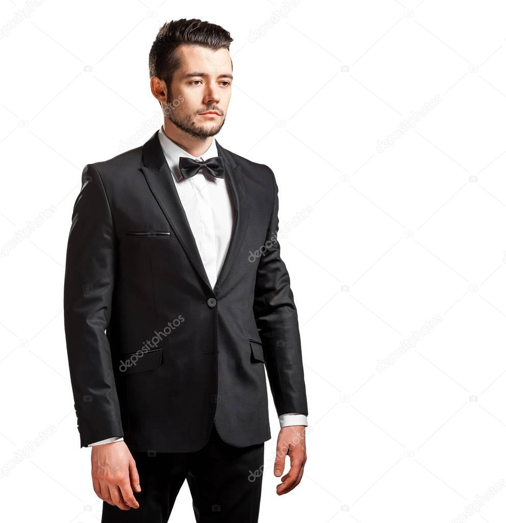 portrait of confident handsome man in black suit with bowtie