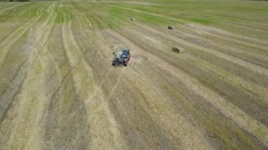 Ukrayna, Kalinovka, 4 Eylül 2017, saman balya üreten saman balya bir alanda - havadan görüntüleri ile yeşil traktör