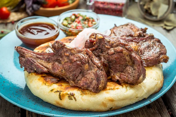 Two pieces of of grilled pork with herbs on a paper — Stock Photo, Image