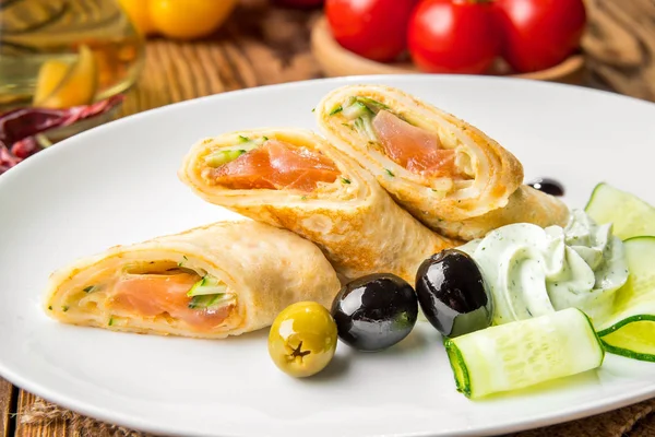 Crepes with smoked salmon on a white plate — Stock Photo, Image