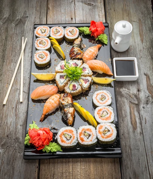 Радужный суши-ролл с лососем, угрем, тунцом, авокадо, королевская креветка, сливочный сыр Филадельфия, икра табика, чука. Меню суши. Японская кухня. — стоковое фото