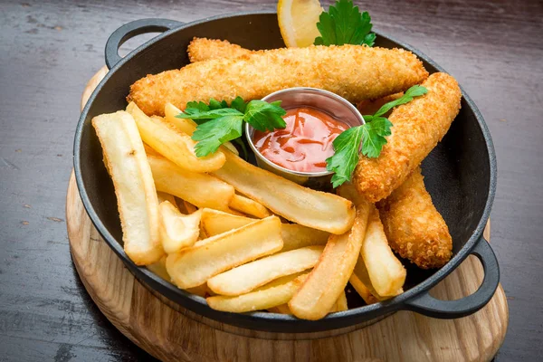 Fish and Chips on wooden table, tasty food. — Stock Photo, Image