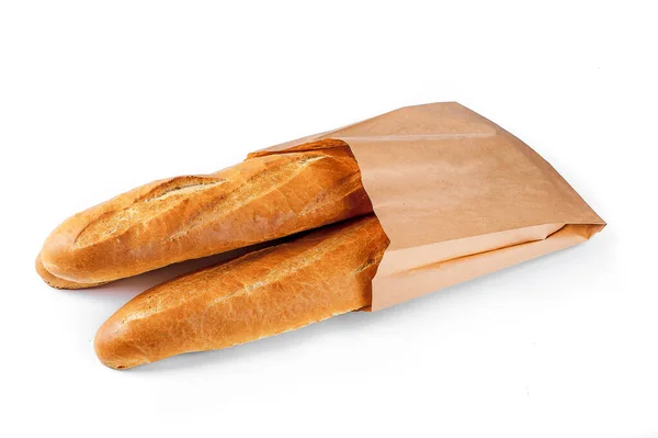 Baguette bread in paper bag on white background — Stockfoto