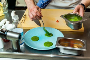 The chef in the restaurant prepares a dish