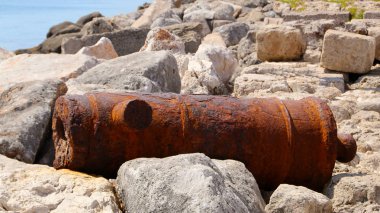 Old rusty cannon near the walls of Fort of Saint Nicholas, Mandraki Harbour, Rhodes, Greece