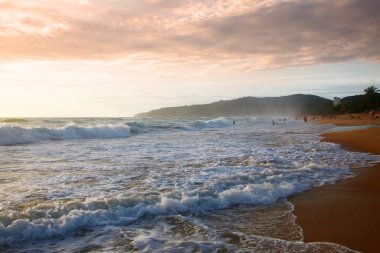 Beautiful sunset on tropical beach. The surf pounds the shore. Karon beach, Phuket, Thailand
