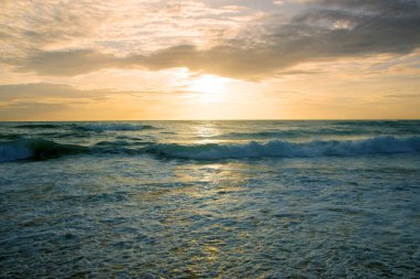 Beautiful sunset on tropical beach. The surf pounds the shore. Karon beach, Phuket, Thailand