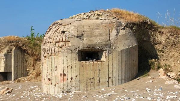 A group of tourists exploring a dark tunnel in a WWII bunker