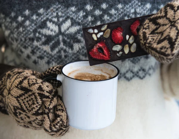 Женщина держит чашку кофе с молоком в теплых перчатках — стоковое фото
