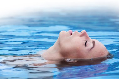 Woman floating in pool clipart