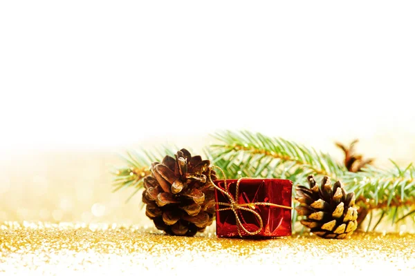 Christmas card with fir branch and decorations on golden gitter background — Stock Photo, Image