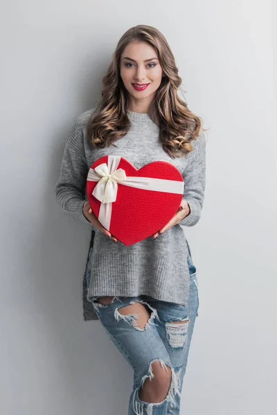 Girl with red heart-shaped box — Stock Photo, Image