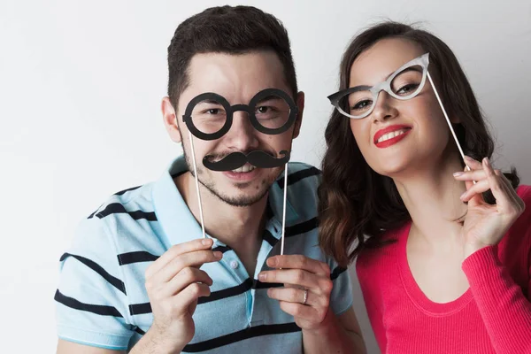 Coppia con bicchieri e baffi da festa — Foto Stock