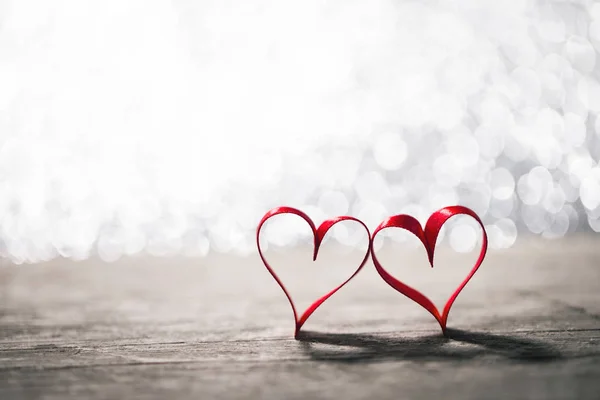 Two ribbon hearts on wood — Stock Photo, Image