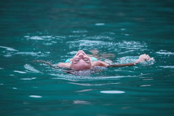 Mujer flotando en el mar — Foto de Stock