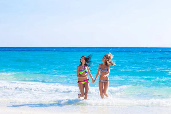 Las mujeres en bikni corren a la playa —  Fotos de Stock