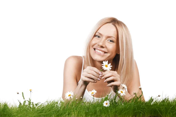 Woman on grass with flowers — Stock Photo, Image