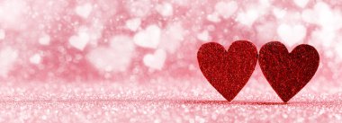 Two red hearts on bokeh background clipart