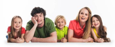 Happy family of parents and three children laying on floor isolated on white background clipart