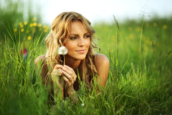 春の牧草地にタンポポを持つ女の子私はコンセプトが欲しい — ストック写真