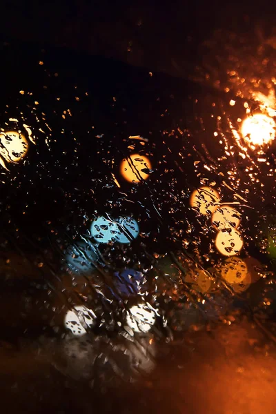 Rain drops on the window. Bokeh night city.