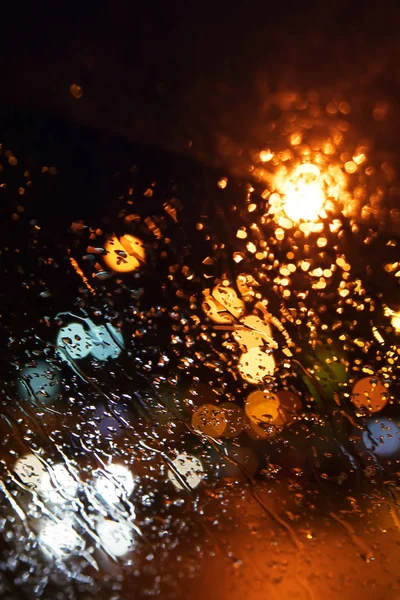 Rain drops on the window. Bokeh night city.