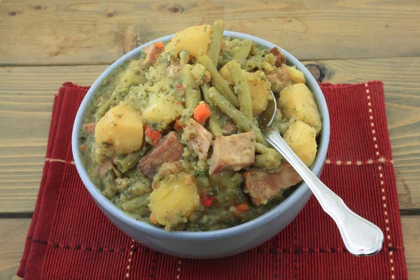 Slow cooked potatoes, green beans, ham, stew Stock Image