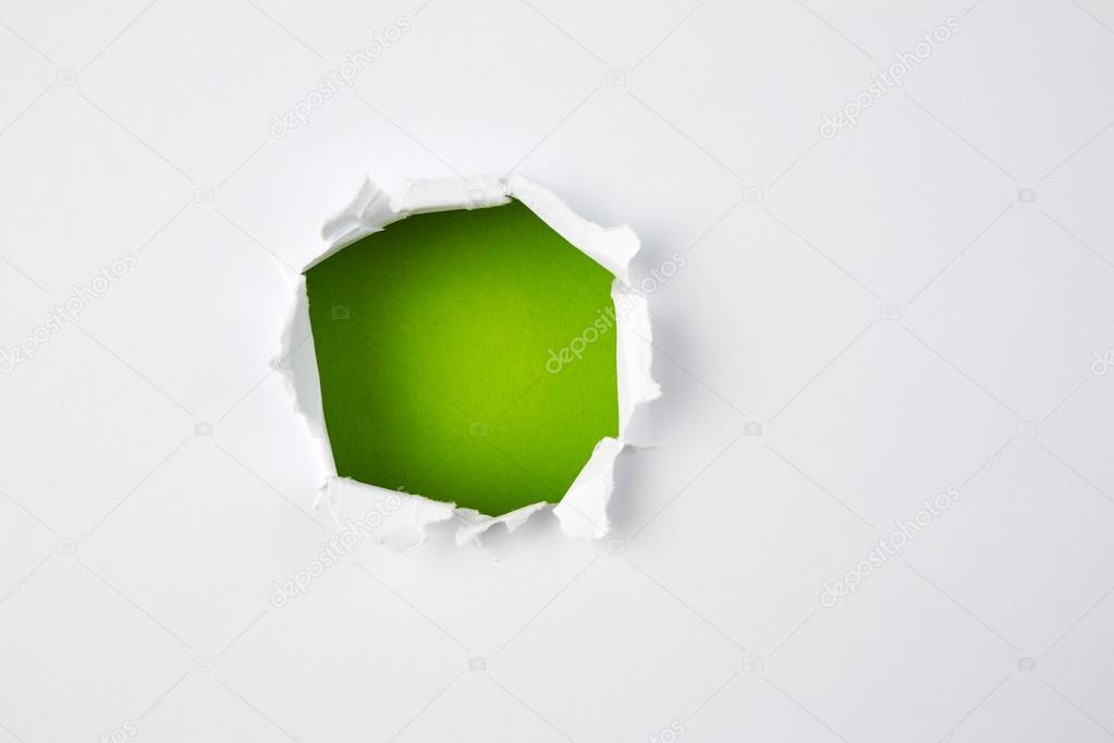 Green hole in torn paper