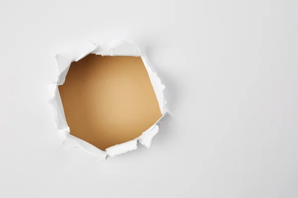 Torn paper with beige hole — Stock Photo, Image