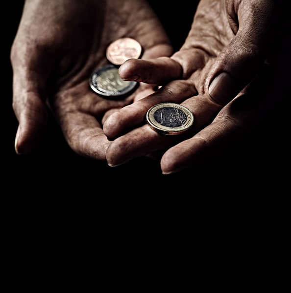 Beggar hands with coins
