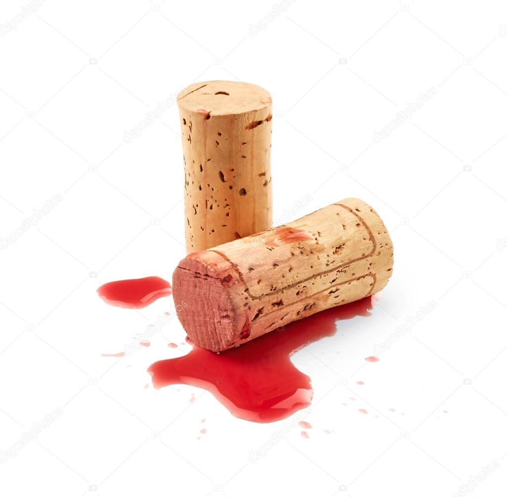 Spilled red wine with corks