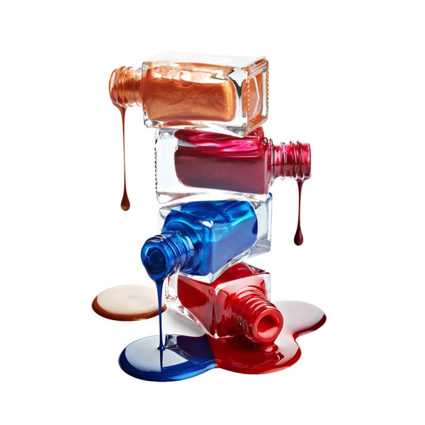 Bottles with spilled nail polish over white background — Stock Photo ...