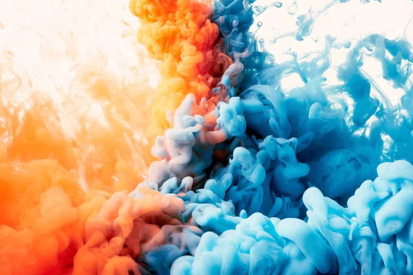 Closeup of splash of blue and orange paint, abstract background