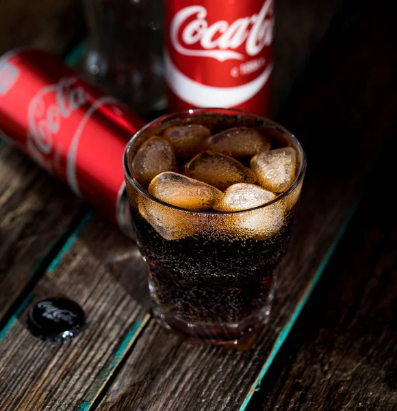 CocaCola with ice cubes in original cup. Stock Editorial Photo