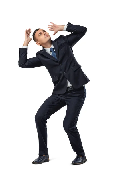 Young businessman in defensive pose afraid of something isolated on white background — Stock Photo, Image