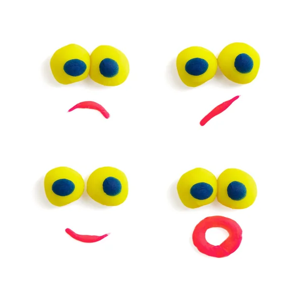 Four funny faces - eyes and mouths - made of multicolored plasticine with different expressions on the white background. — Stock Photo, Image