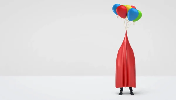 Un hombre de negocios escondido bajo un paño rojo brillante que tiene varios globos de colores atados a su centro . — Foto de Stock