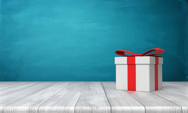 3d rendu d'une boîte cadeau blanche solitaire avec un arc rouge debout sur un bureau en bois devant un fond bleu . — Photo