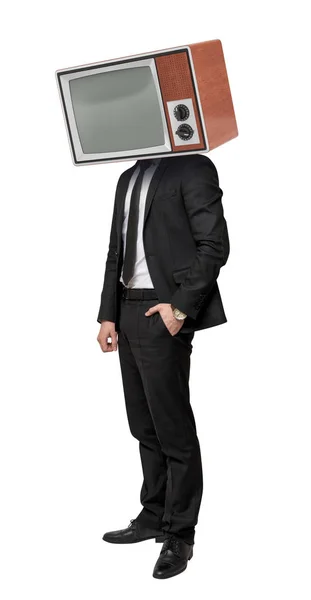 A businessman stands on a white background with one hand in a pocket and a TV box on his head. — Stock Photo, Image