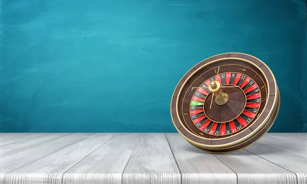 3d rendering of a casino roulette stands on its side on a wooden desk in front of a blue background.
