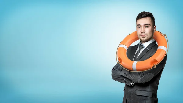 A businessman in a front view with hands crossed and an orange life buoy hanging on his neck.