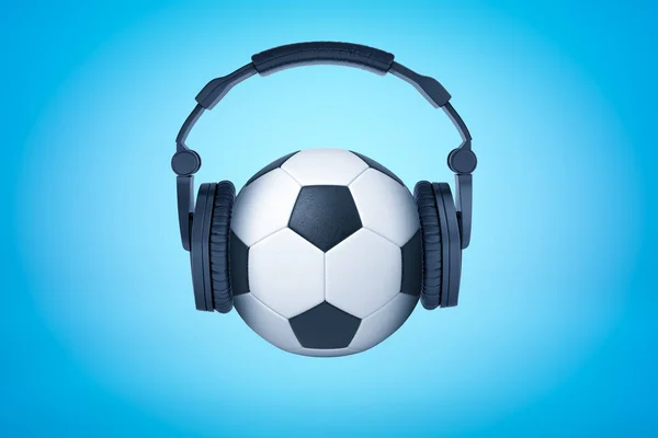 3d renderização de uma bola de futebol com fones de ouvido pretos em como na cabeça humana no fundo azul claro . — Fotografia de Stock
